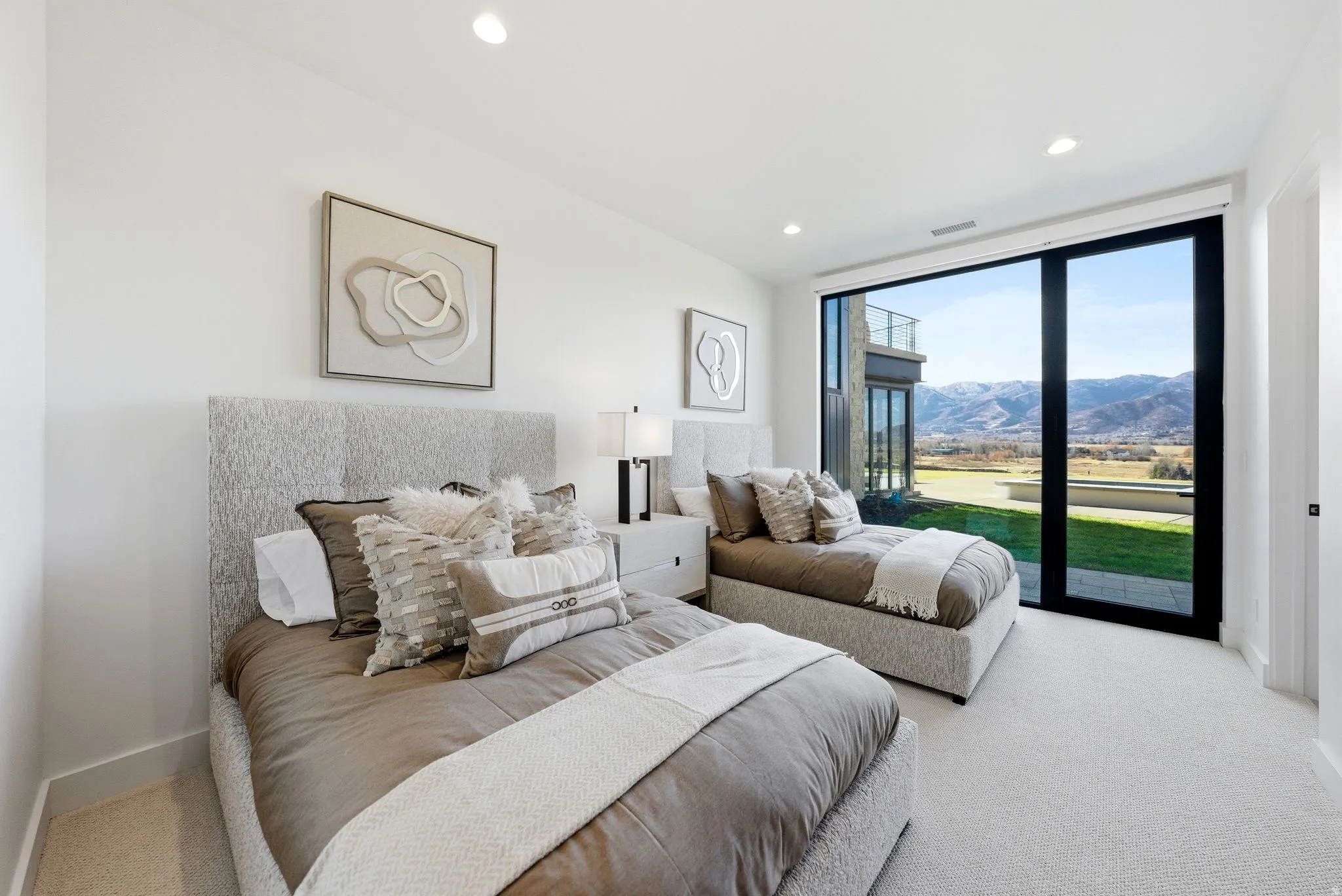 Carpeted bedroom with access to exterior, floor to ceiling windows, a mountain view, and recessed lighting