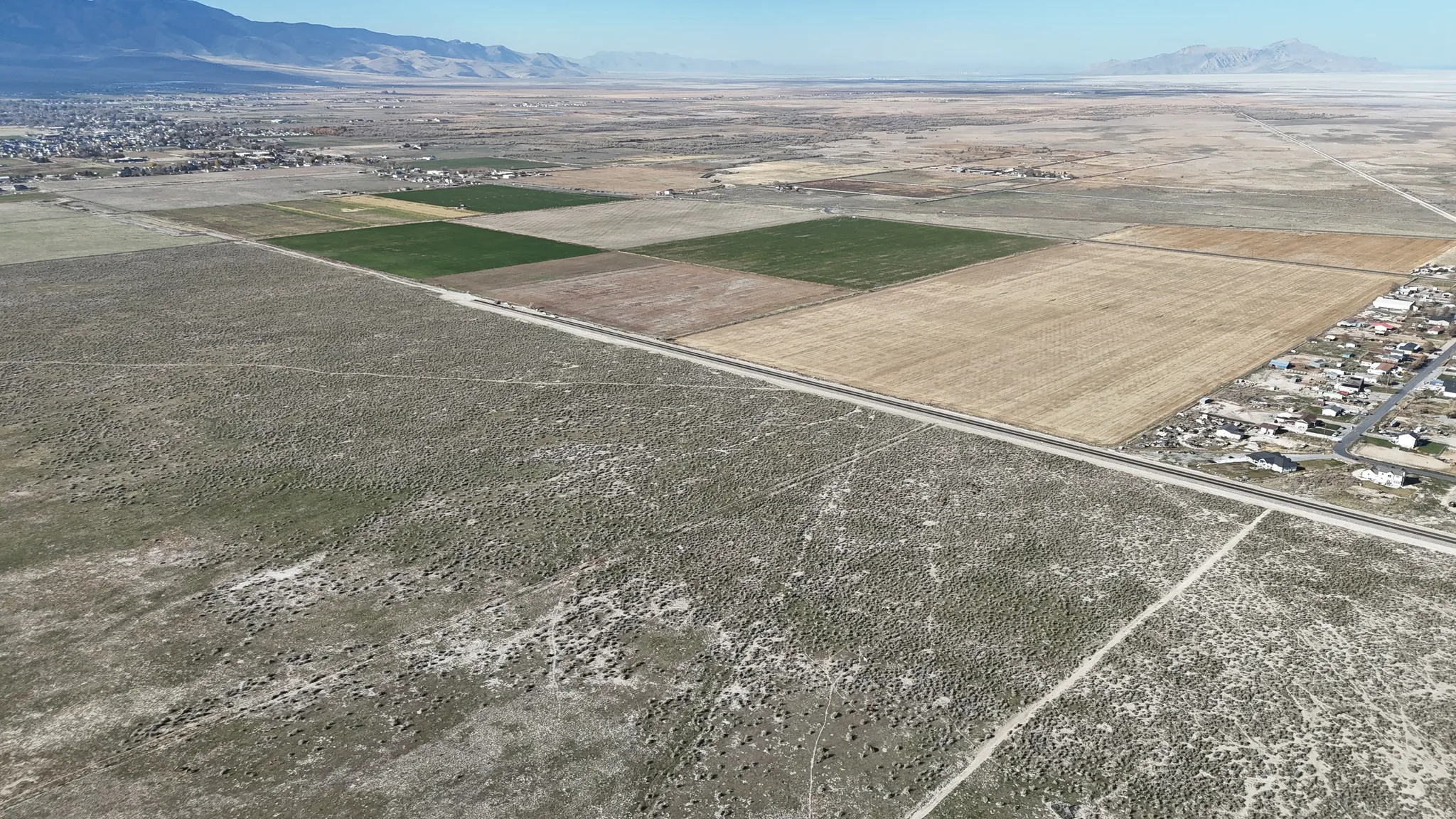 Aerial view of sparsely populated area with a mountain backdrop