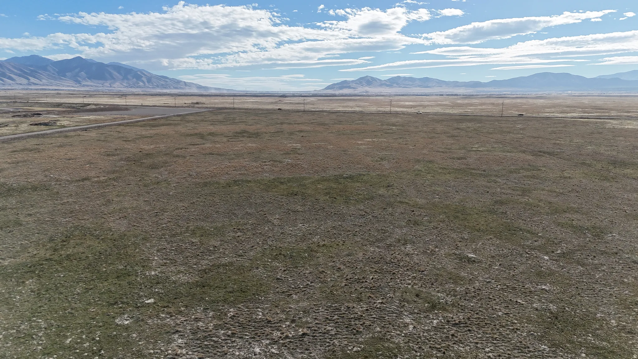 View of mountain backdrop with rural landscape