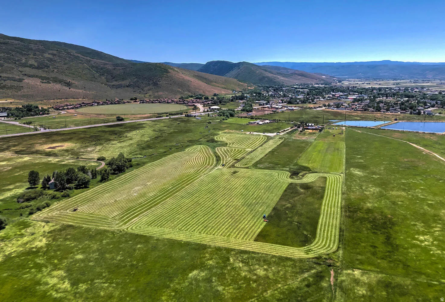 Aerial view of sparsely populated area featuring a water and mountain view and abundant farmland
