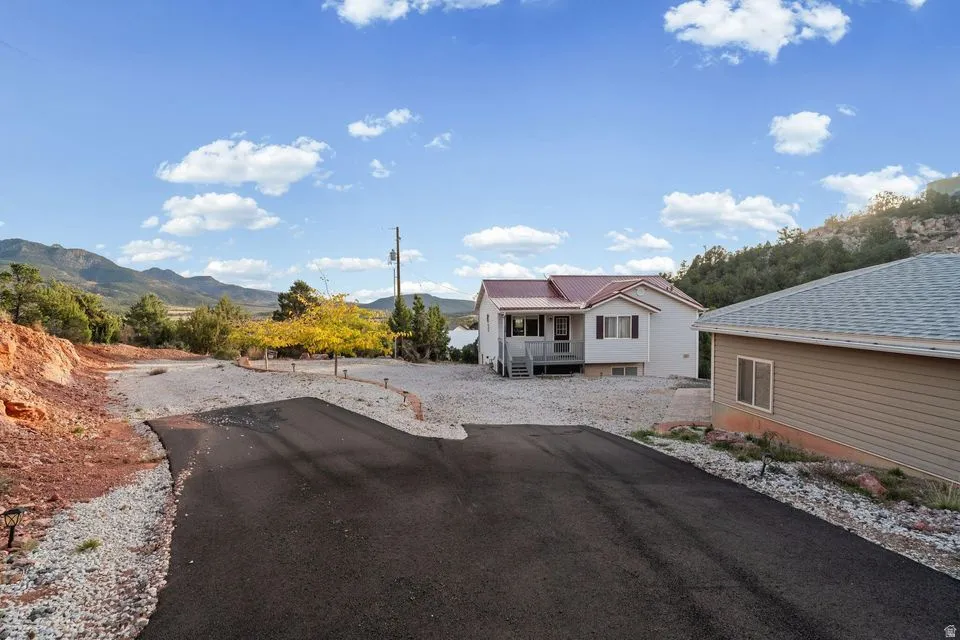 View of asphalt driveway with a mountain view