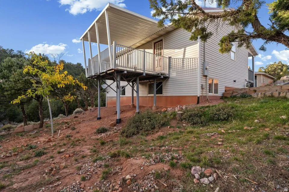 View of side of home featuring a wooden deck