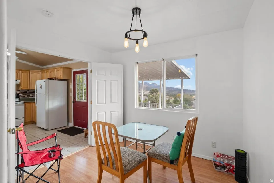 Dining space with light wood-style floors, healthy amount of natural light, and a mountain view