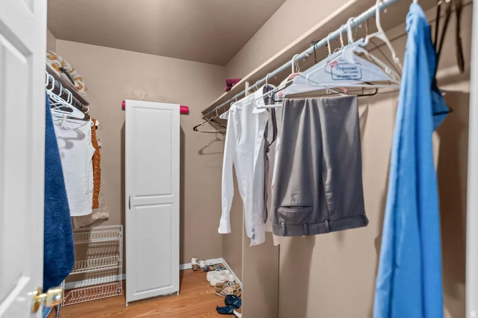 Spacious closet with light wood-style flooring