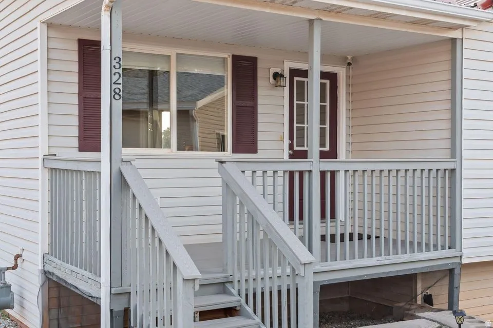 Doorway to property with covered porch