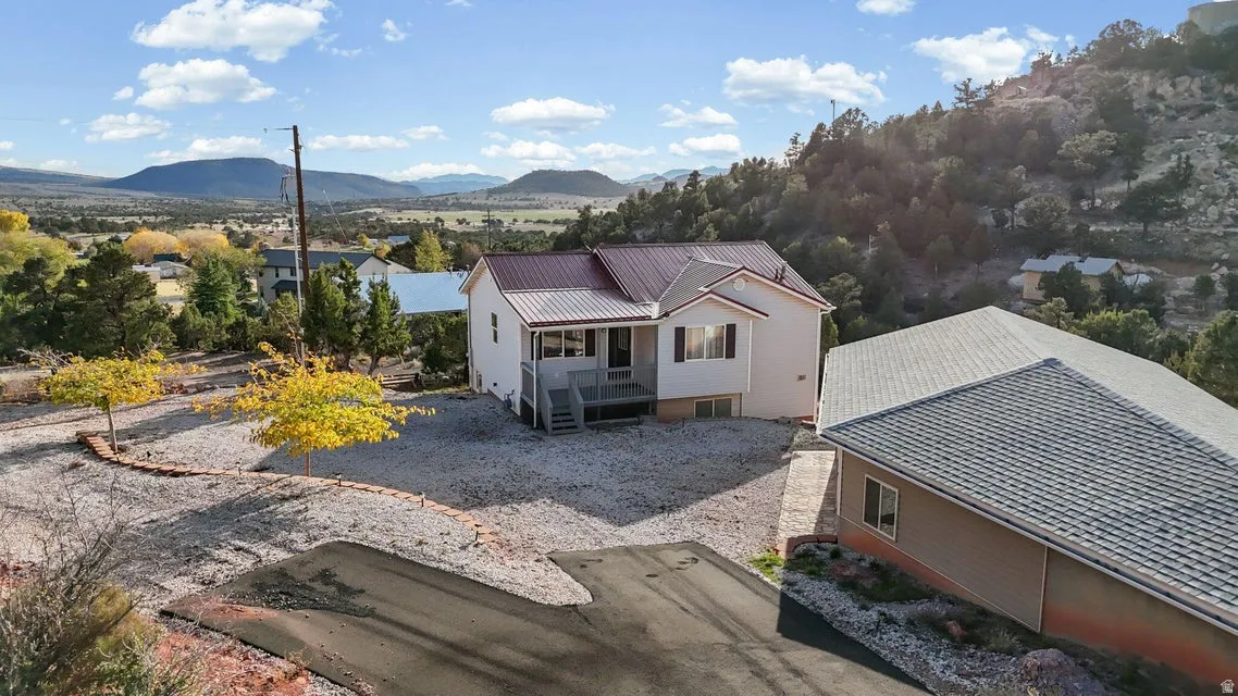 View of front of home featuring a metal roof and a deck with mountain view