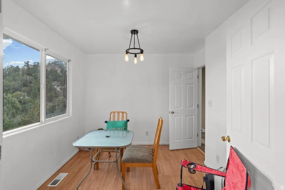 Dining room with light wood-style floors and baseboards