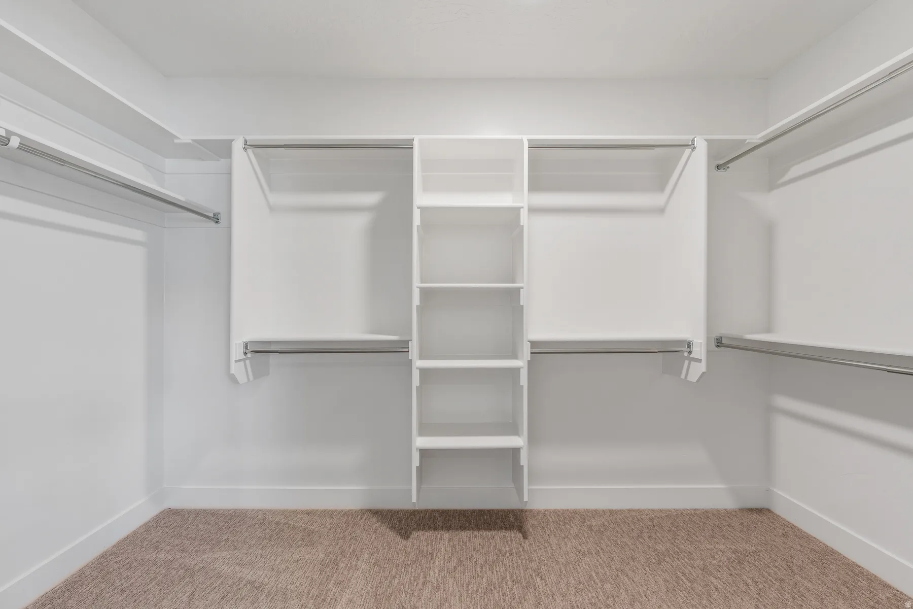 Walk in closet featuring light carpet