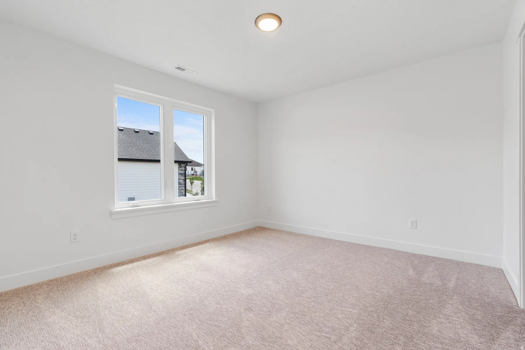 Unfurnished room with light colored carpet