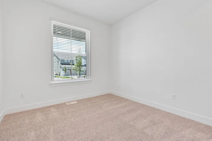 Empty room with carpet floors and baseboards