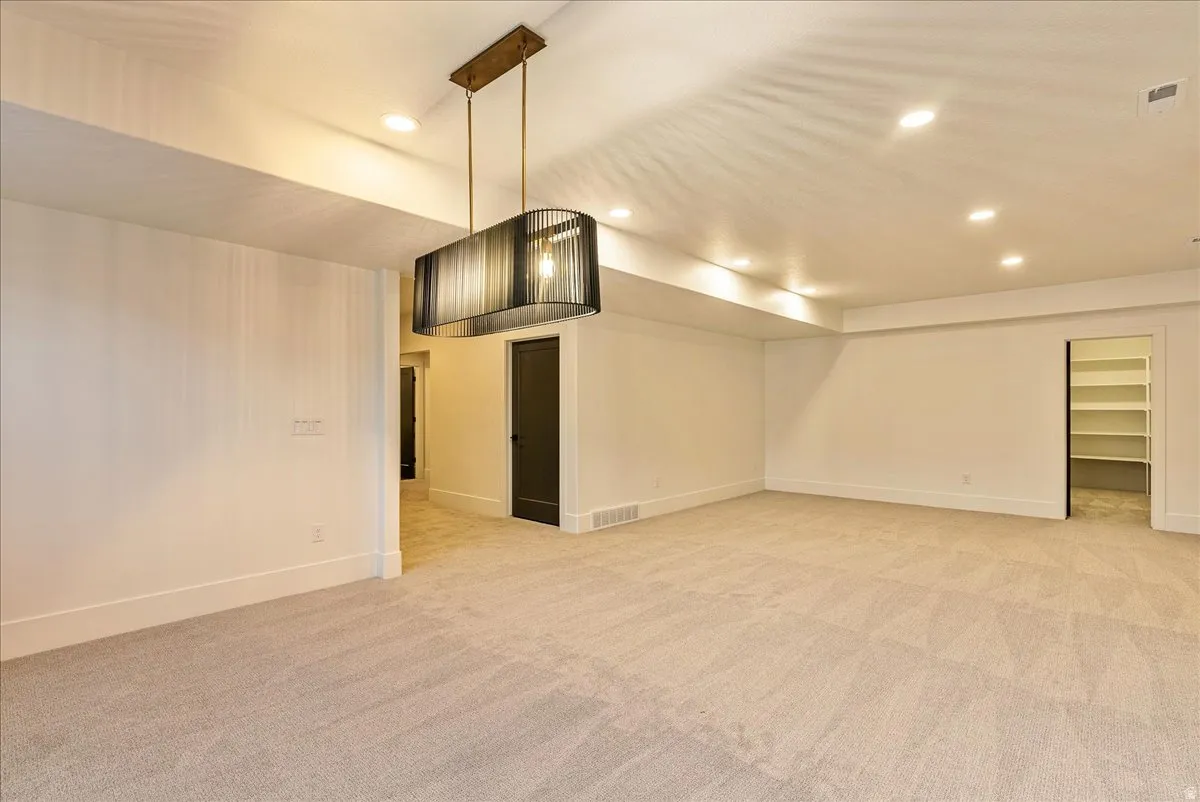 Spare room with recessed lighting and light colored carpet