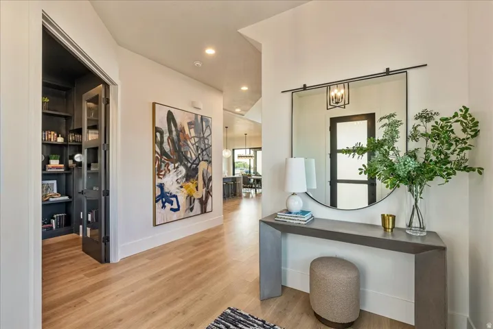 Hall with recessed lighting and light wood-style floors