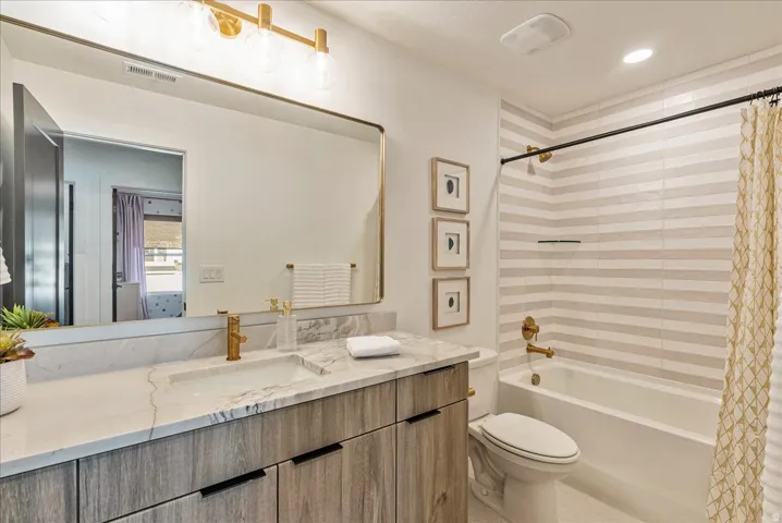 Full bathroom featuring shower / tub combo with curtain and vanity