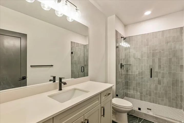 Full bath with a stall shower and vanity