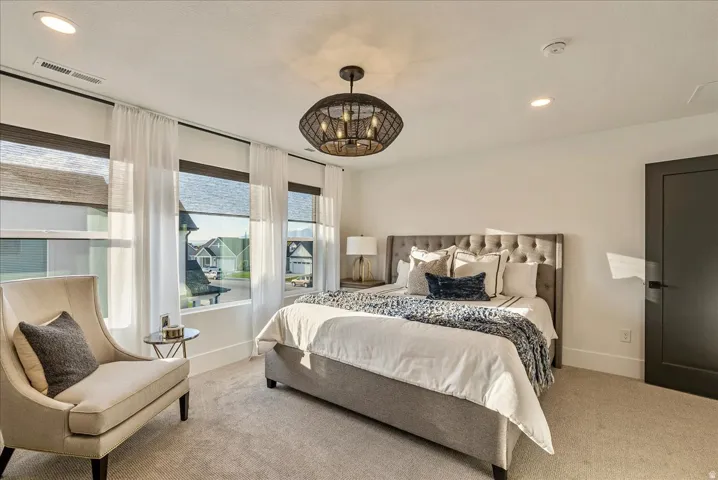 Primary Bedroom featuring recessed lighting, carpet, and a chandelier