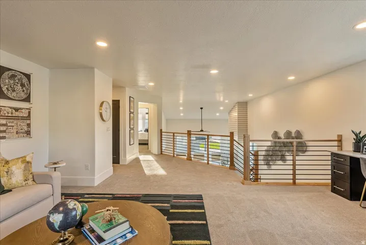 Loft area featuring light colored carpet, recessed lighting, and a textured ceiling