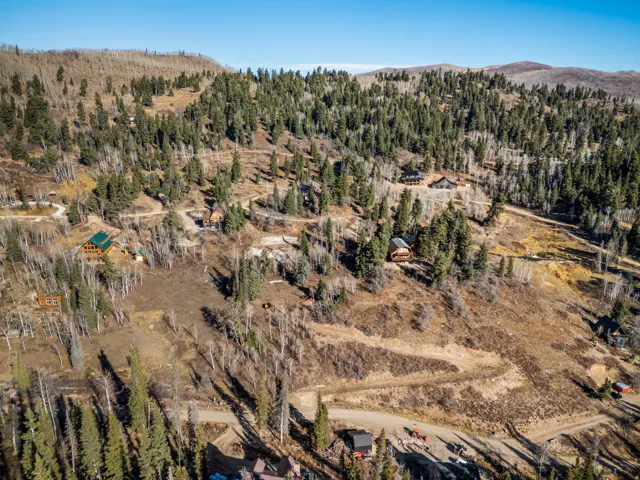 View of property location featuring a forest and a mountain backdrop