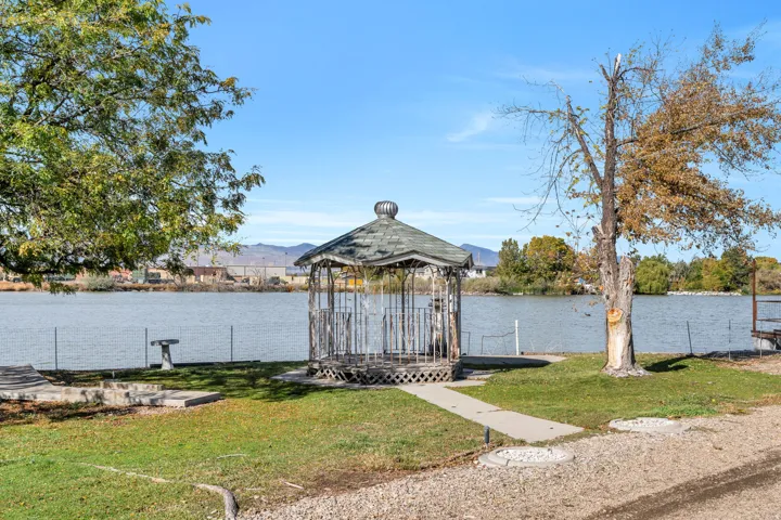 Dock featuring a yard and a water and mountain view