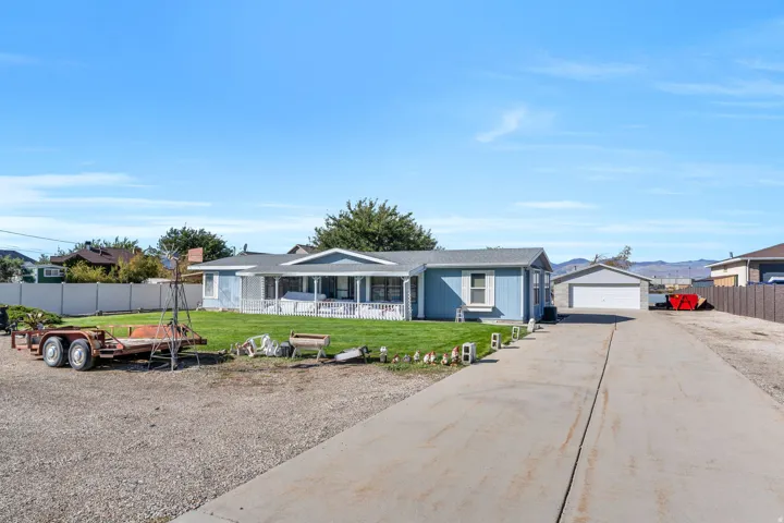 Ranch-style house with a garage and an outbuilding