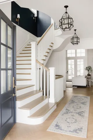 Entrance foyer featuring stairway and light wood-style floors