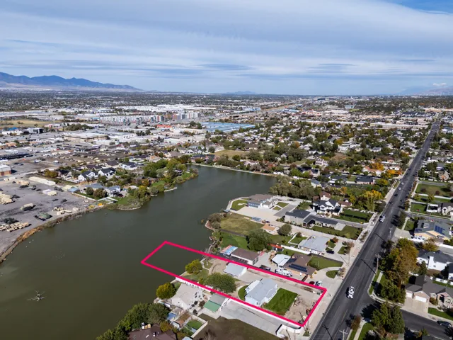 Aerial perspective of suburban area with a water and mountain view and property boundaries highlighted