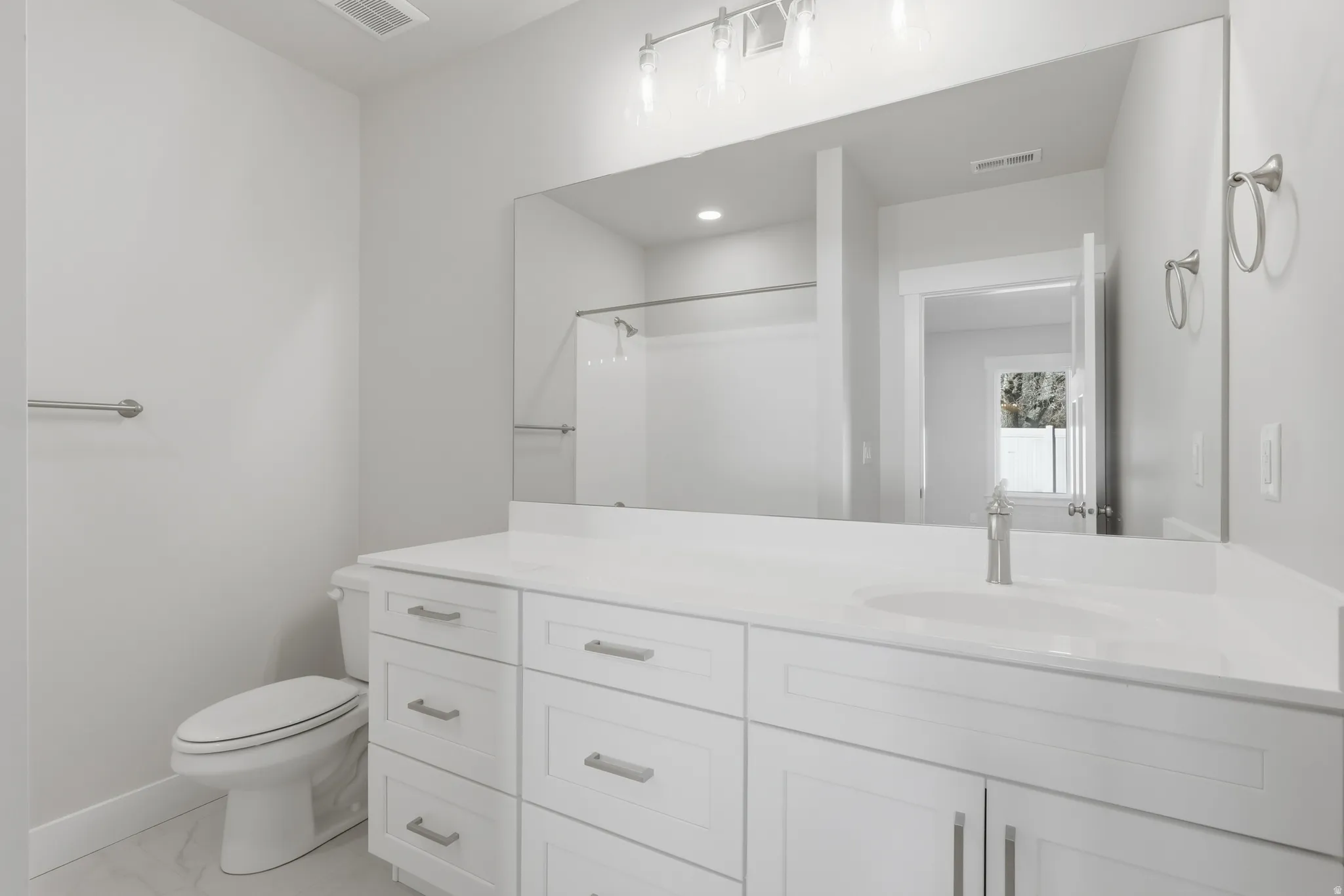 Bathroom with vanity and a shower