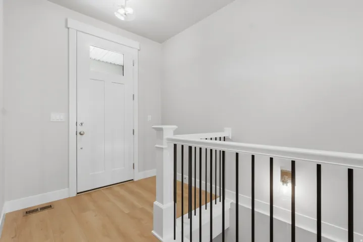 Entryway with light wood-style floors and baseboards