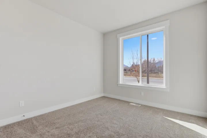 Unfurnished room with carpet flooring and baseboards