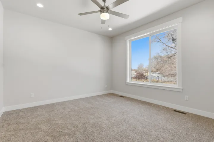 Carpeted empty room with recessed lighting and a ceiling fan