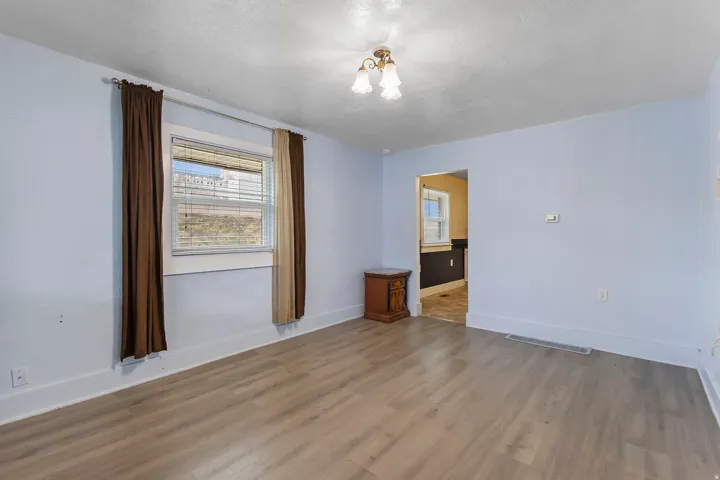 Unfurnished room with wood finished floors and a textured ceiling