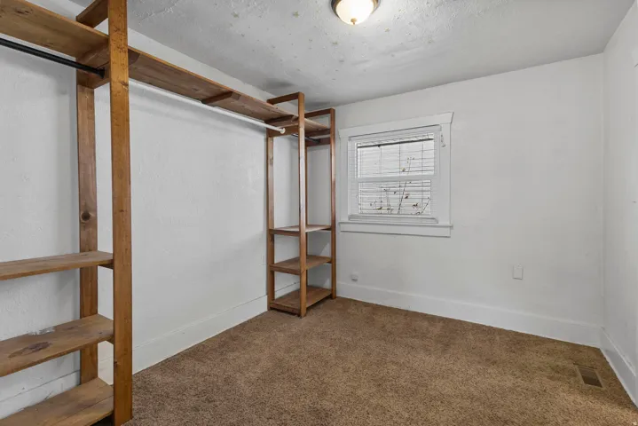 Unfurnished bedroom featuring carpet flooring and a textured ceiling