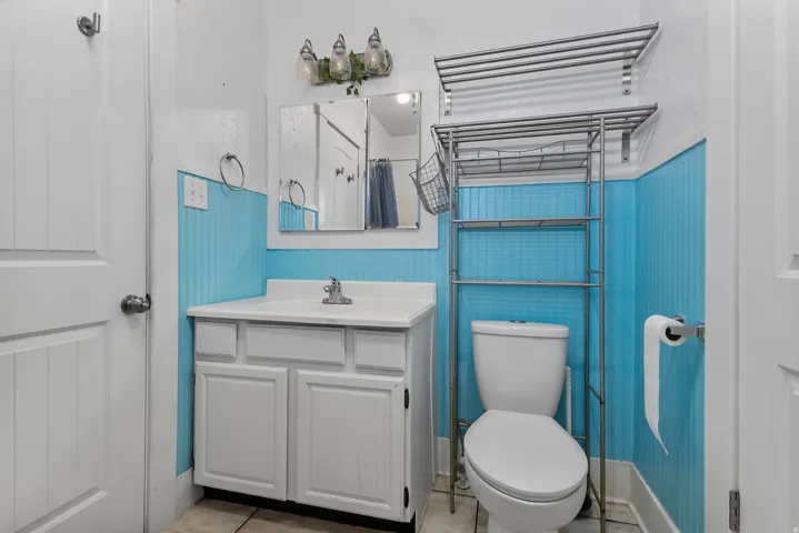 Bathroom featuring a shower with curtain, vanity, and light tile patterned floors