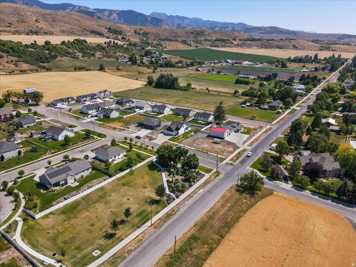 Aerial view of property's location with nearby suburban area and mountains