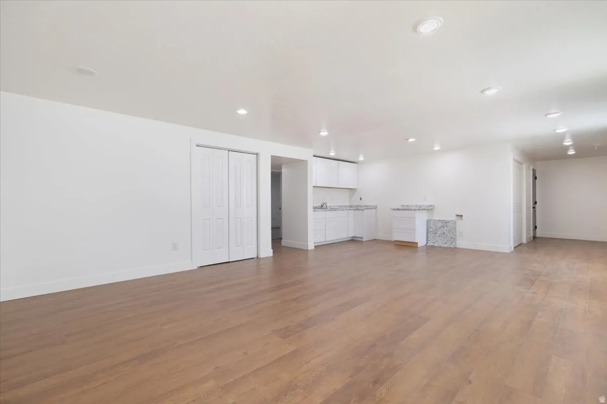 Unfurnished living room featuring light wood-type flooring and recessed lighting