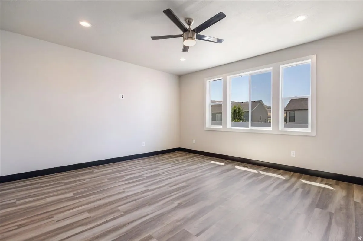 Unfurnished room with wood finished floors, recessed lighting, and a ceiling fan