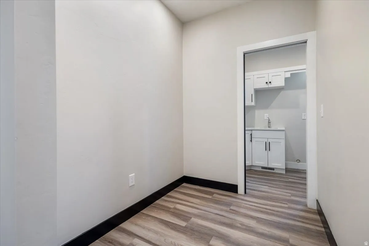Unfurnished room with light wood-style floors and baseboards