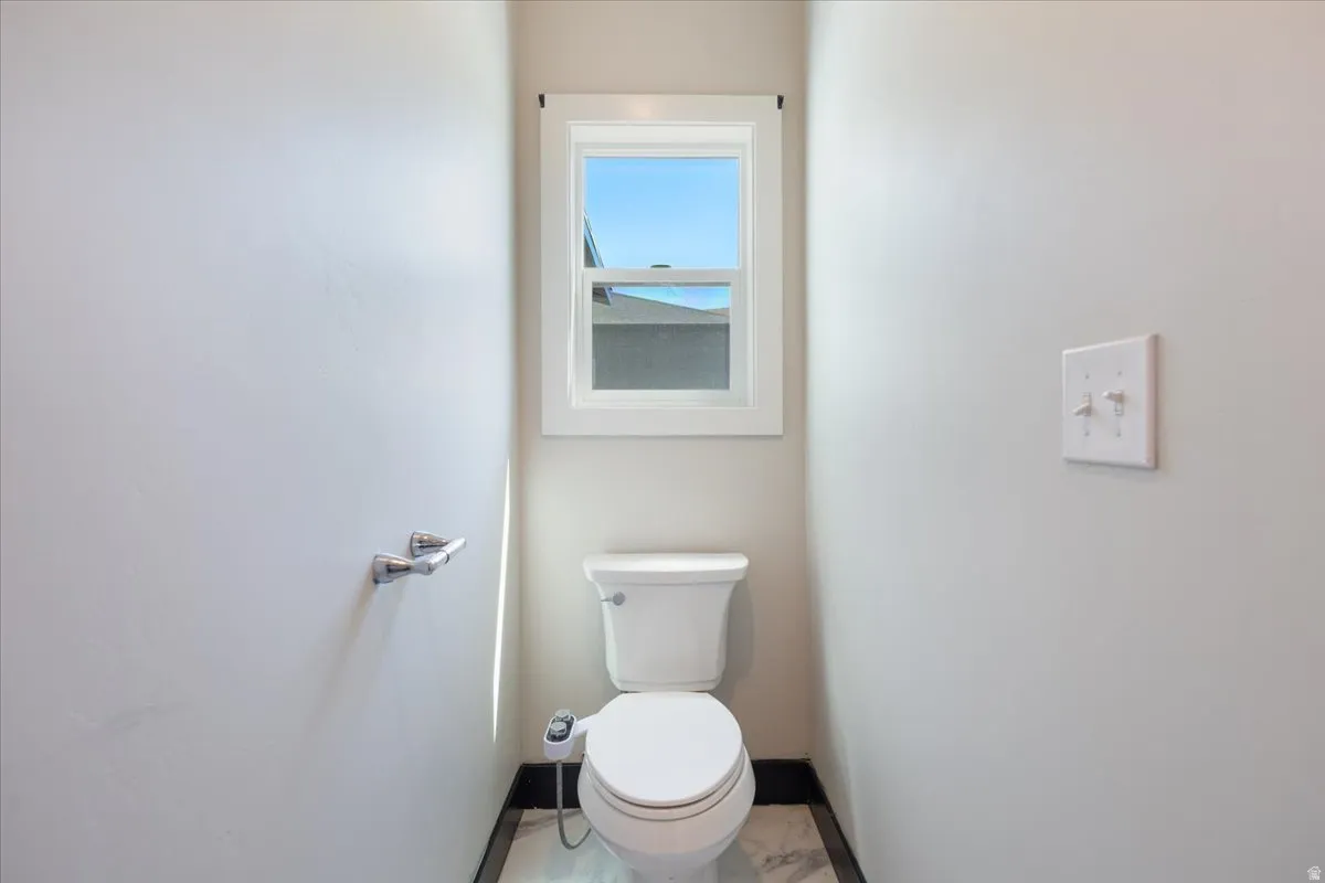 Bathroom featuring baseboards and toilet