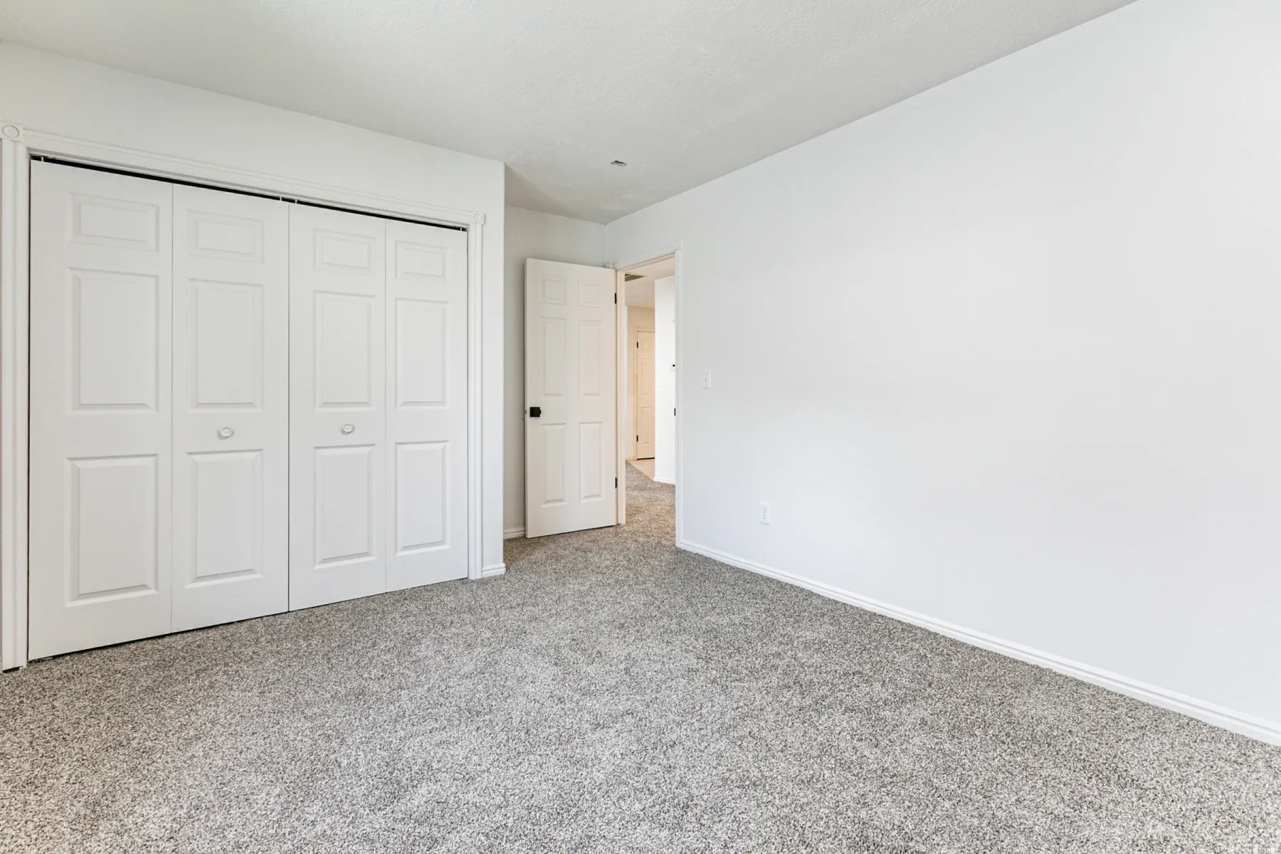 Unfurnished bedroom featuring carpet and a closet