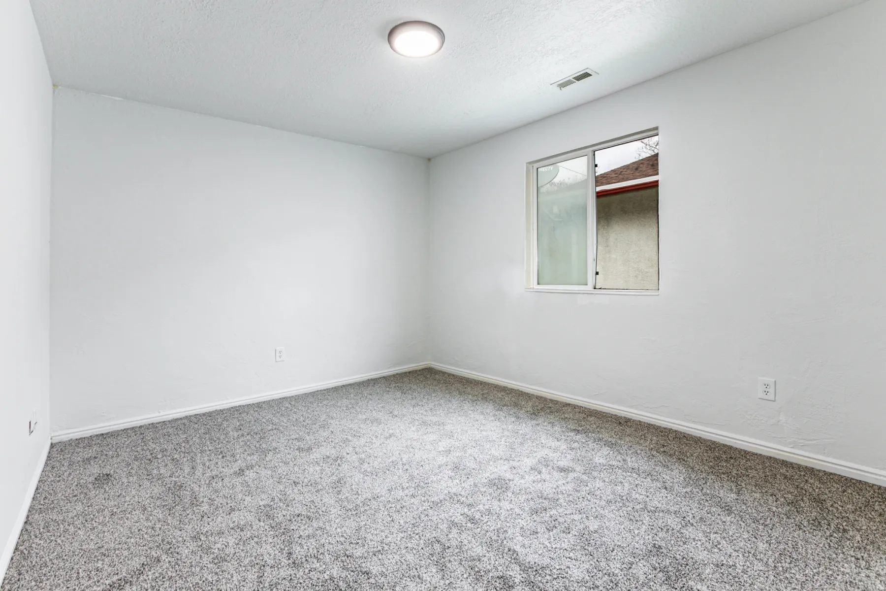 Unfurnished room with carpet floors and a textured ceiling