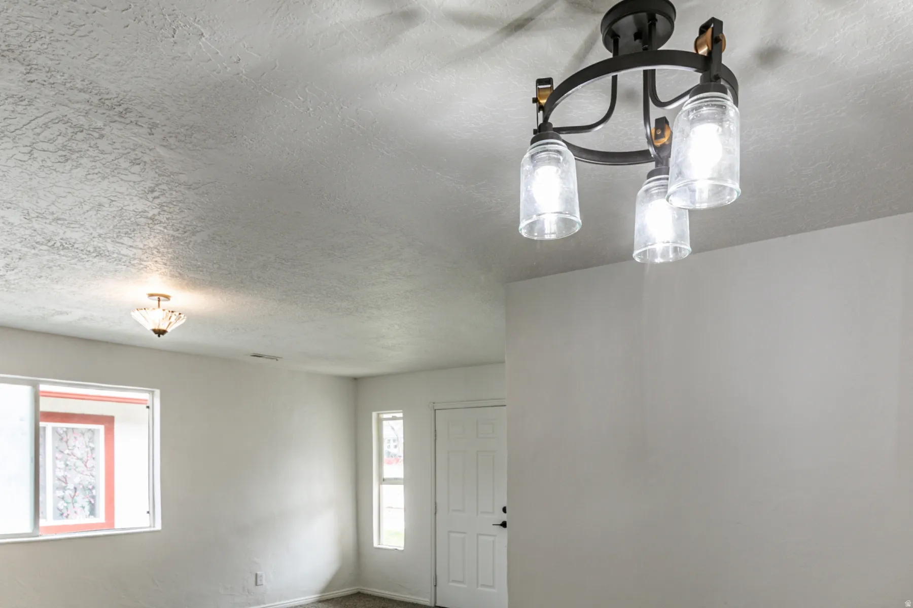 Foyer with a textured ceiling and baseboards