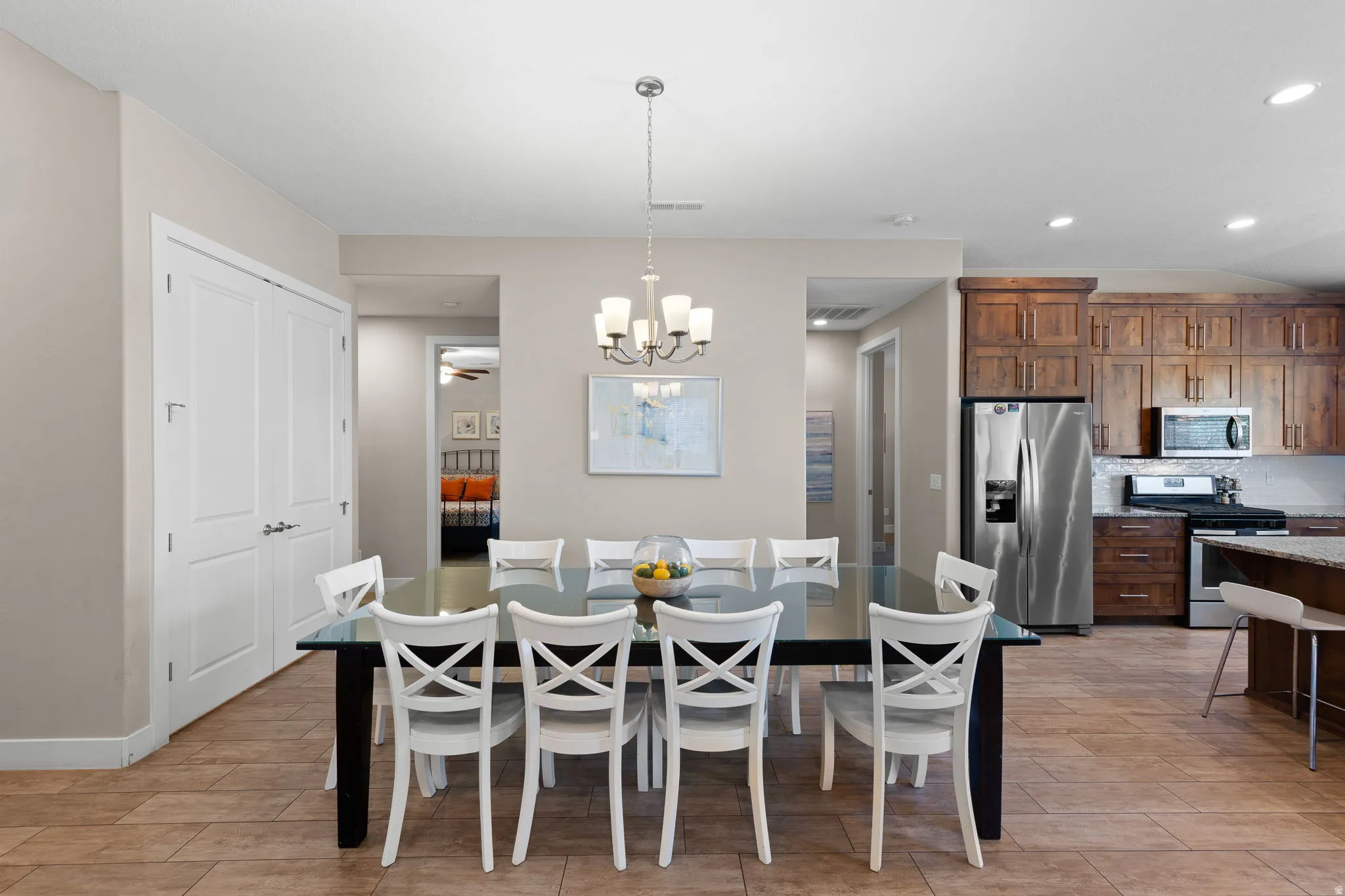 Dining space featuring wood finish floors, recessed lighting, a chandelier, and a ceiling fan