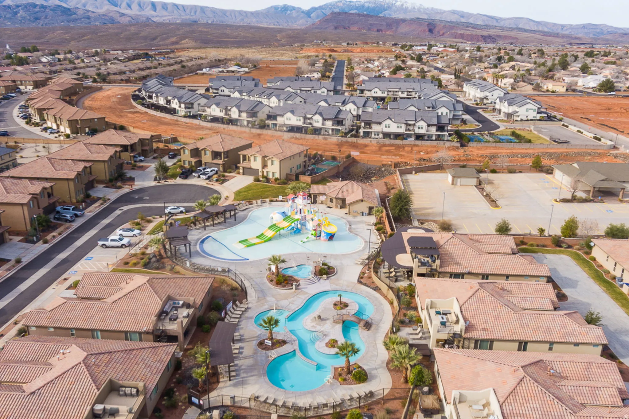 Aerial overview of property's location with nearby suburban area and mountains