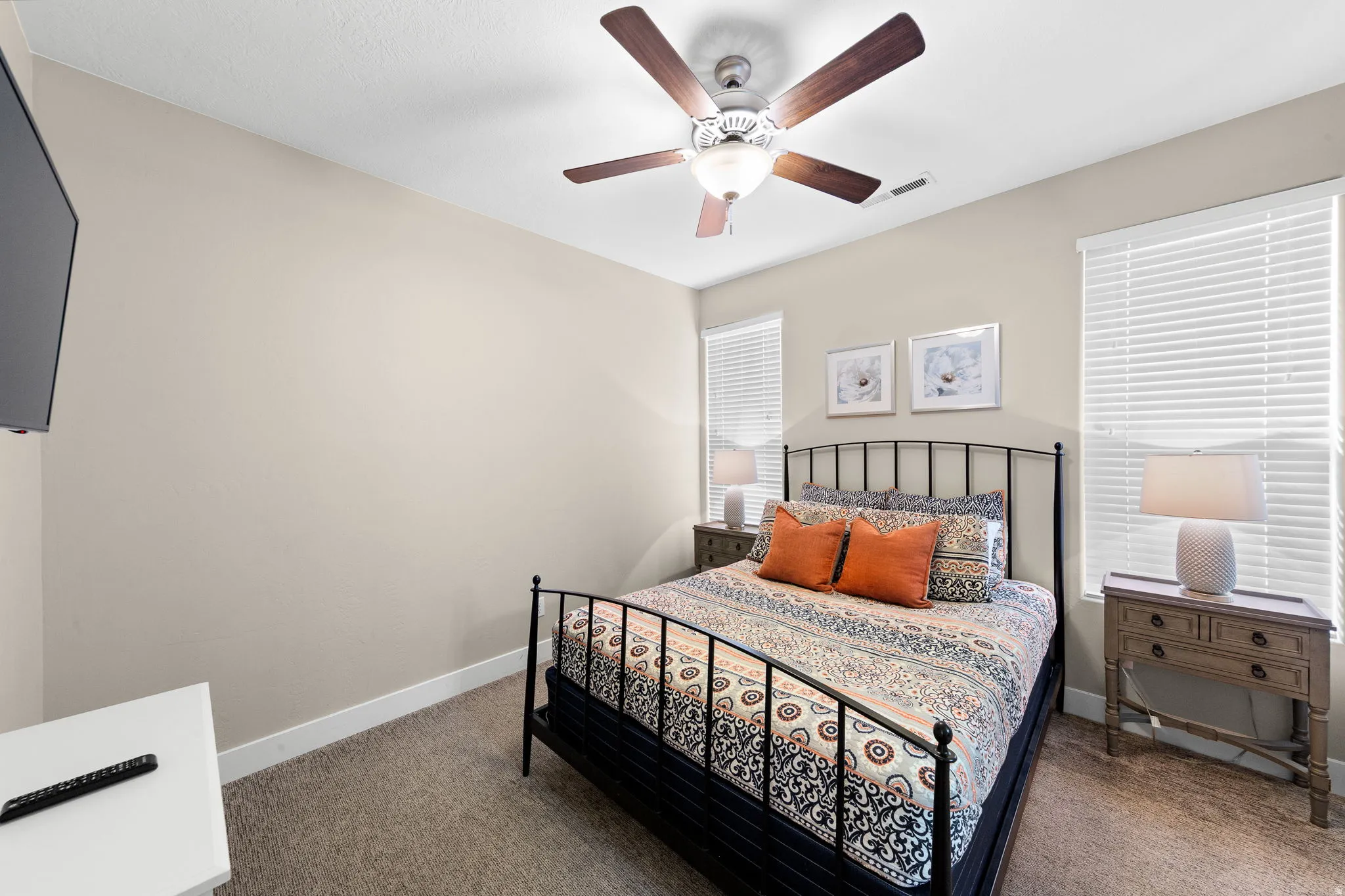 Carpeted bedroom featuring baseboards and ceiling fan