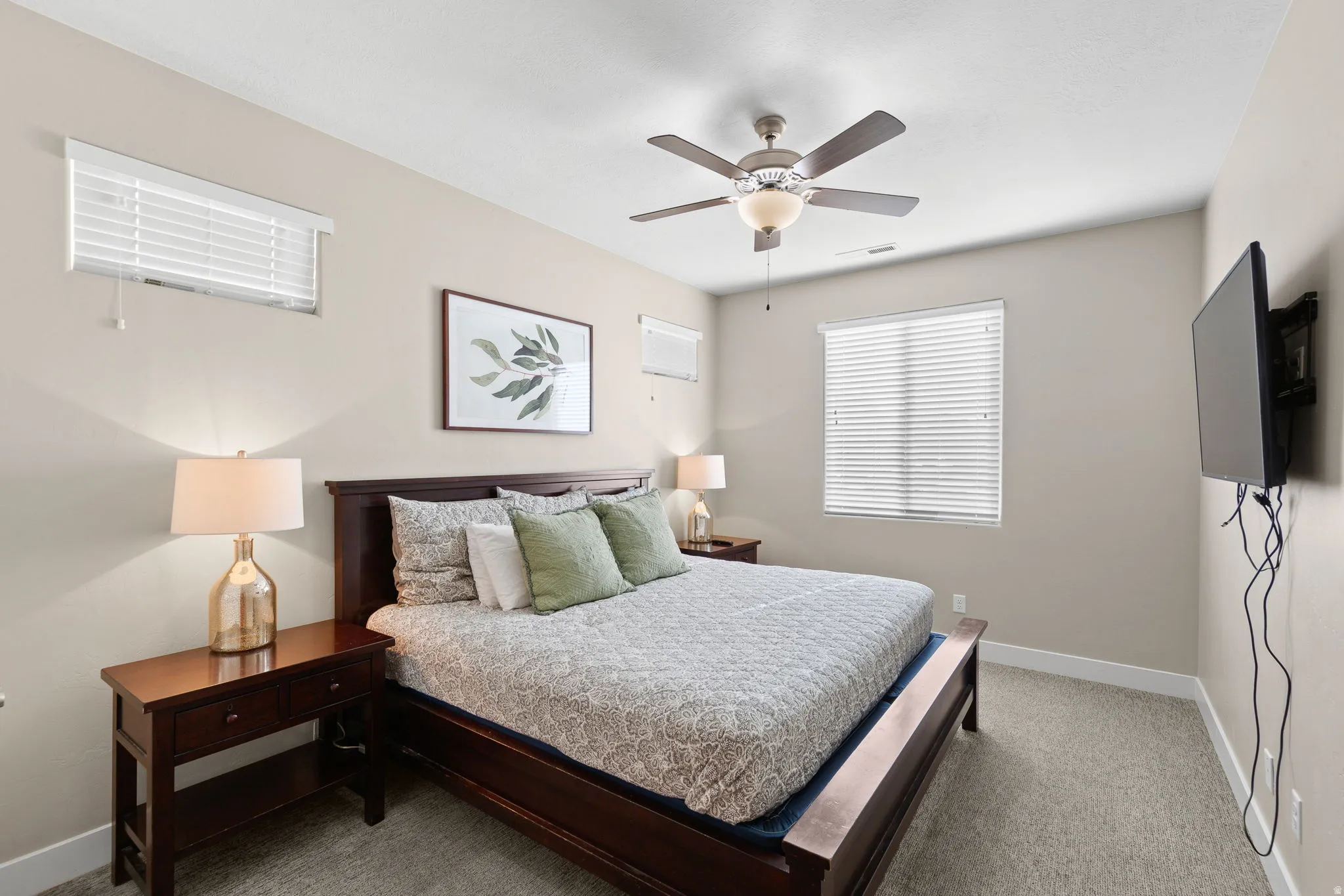 Bedroom featuring a ceiling fan and light carpet