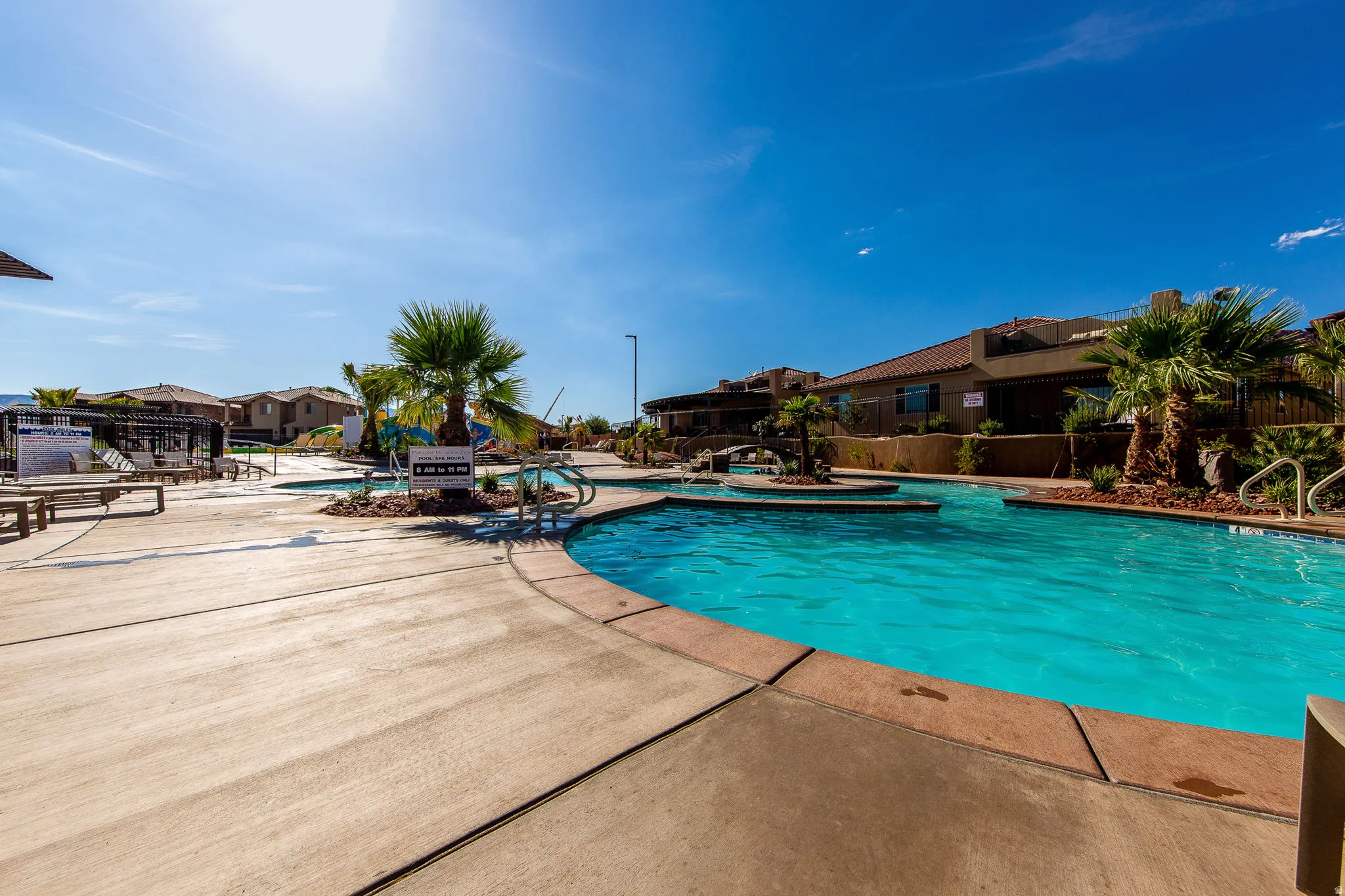 Community pool featuring a patio area and a residential view