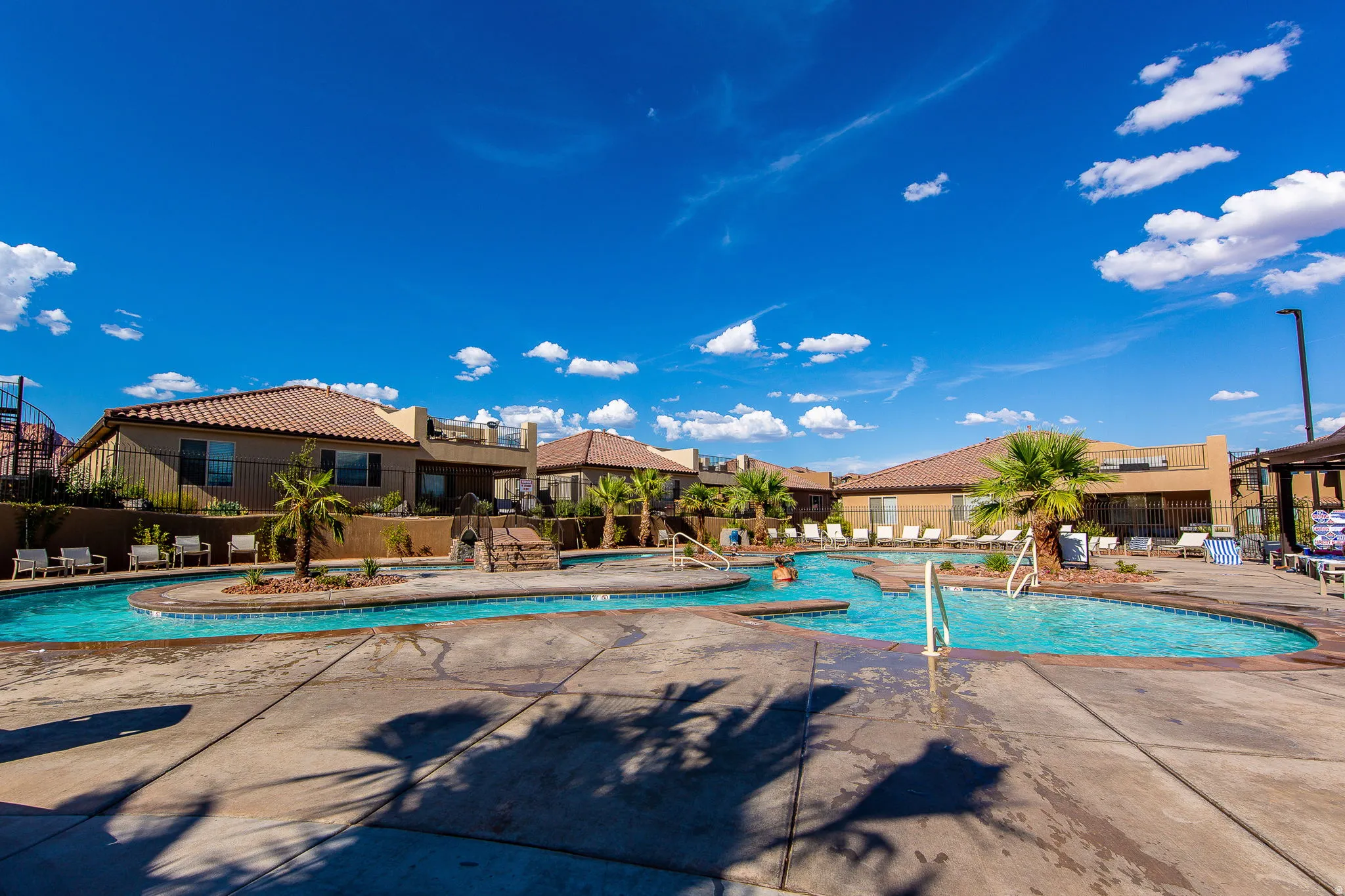 Community pool featuring a patio and a hot tub