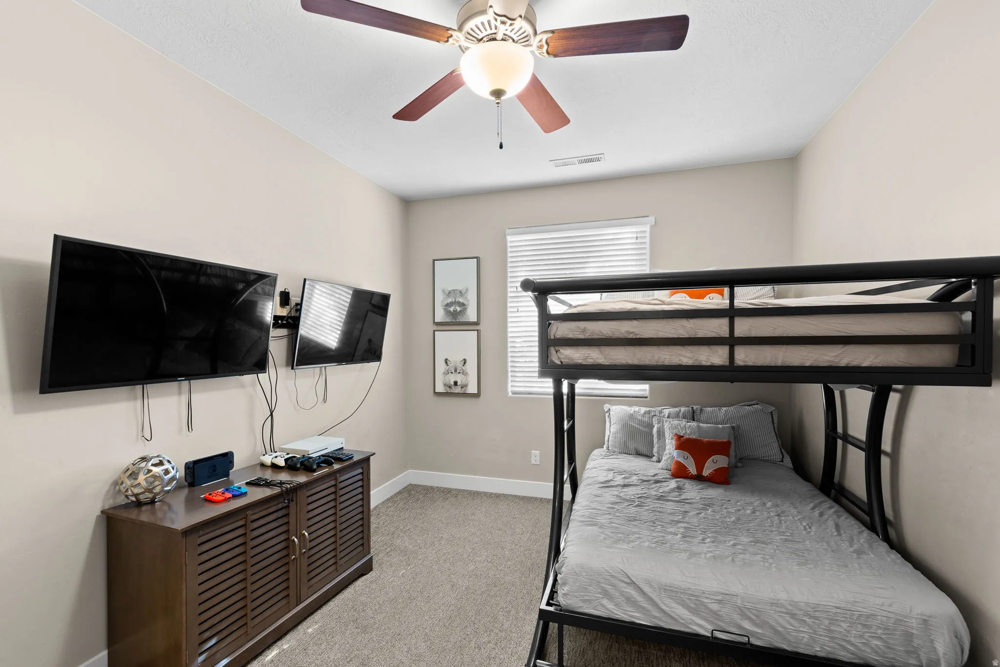 Bedroom with light carpet and a ceiling fan