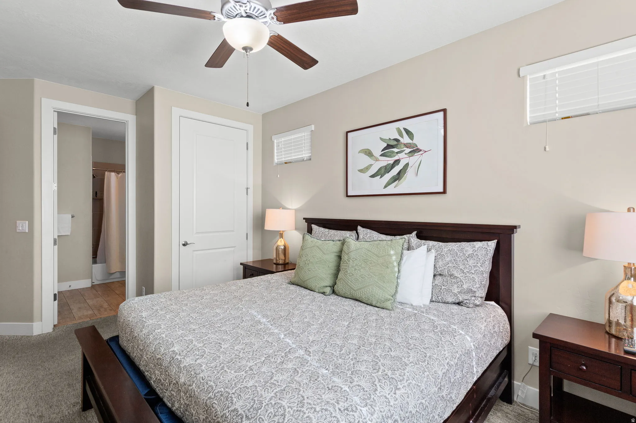 Carpeted bedroom with baseboards and ceiling fan