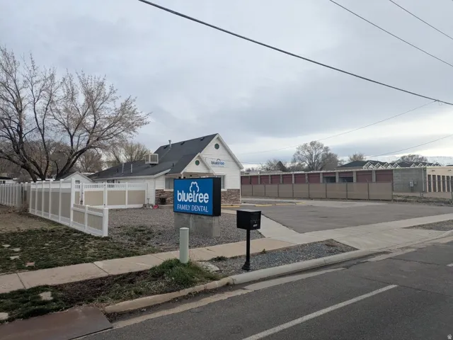 View of asphalt street featuring sidewalks and curbs