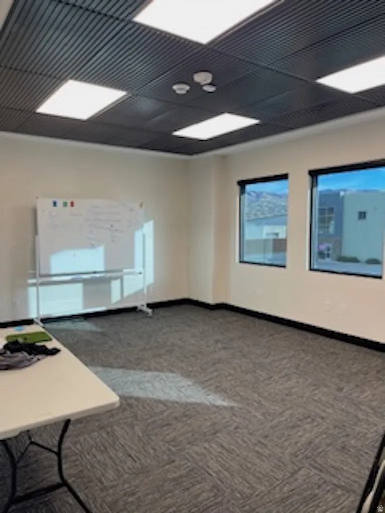 Unfurnished room with carpet flooring and baseboards